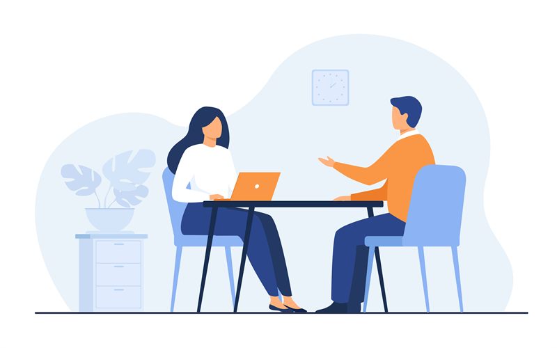 A job seeker with a laptop talking with a hiring manager
